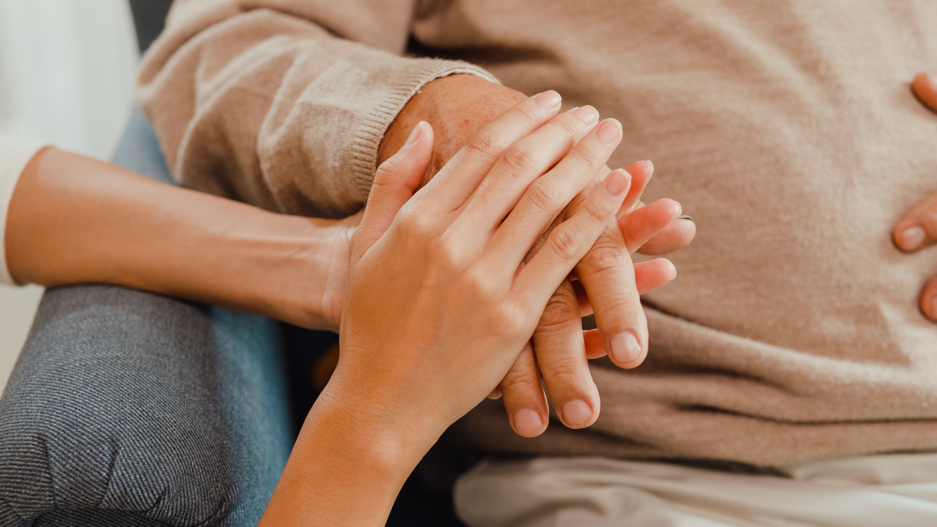 family supporting senior patient in palliative care treatment