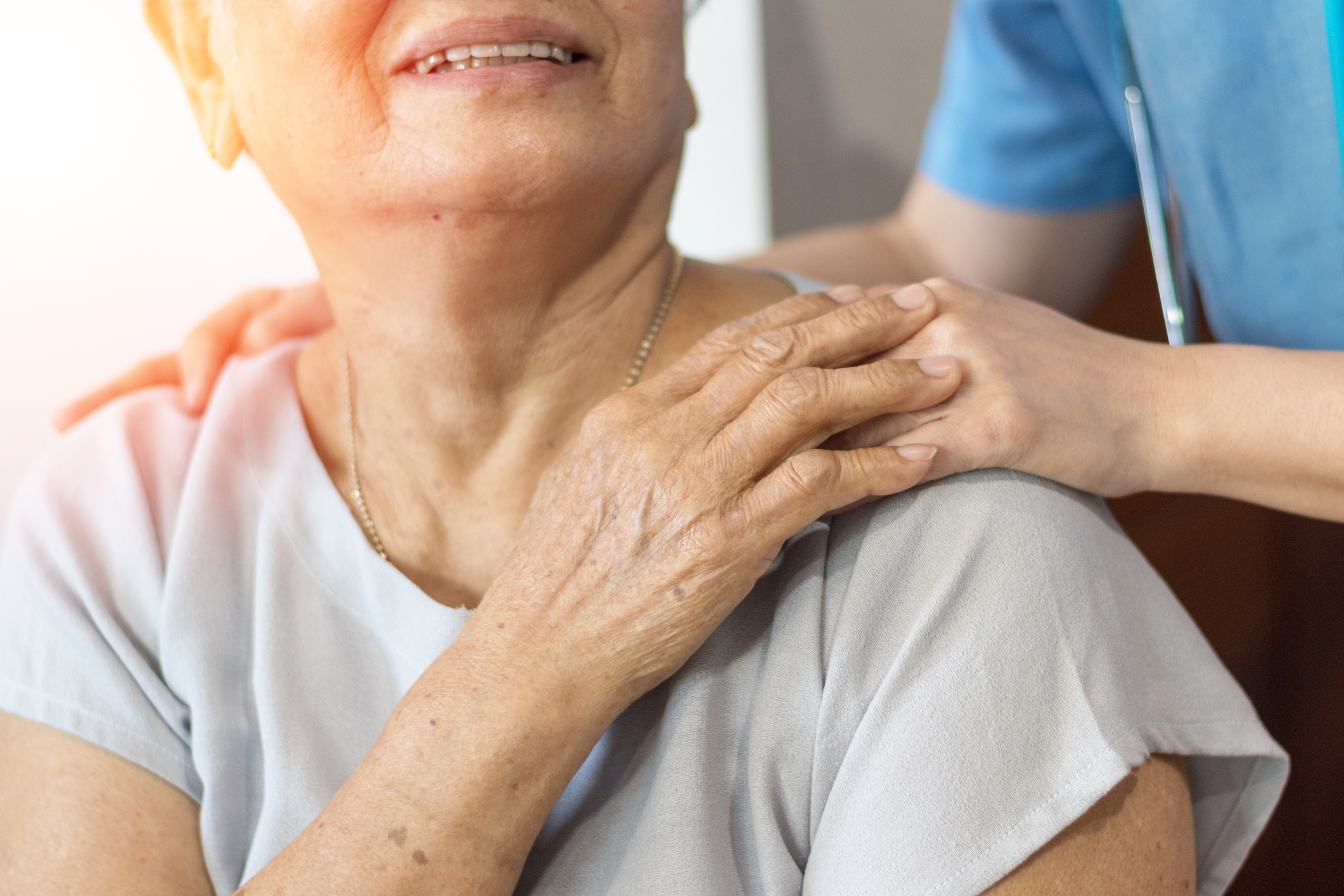 Elder woman with her caregiver representing when it is time for palliative care