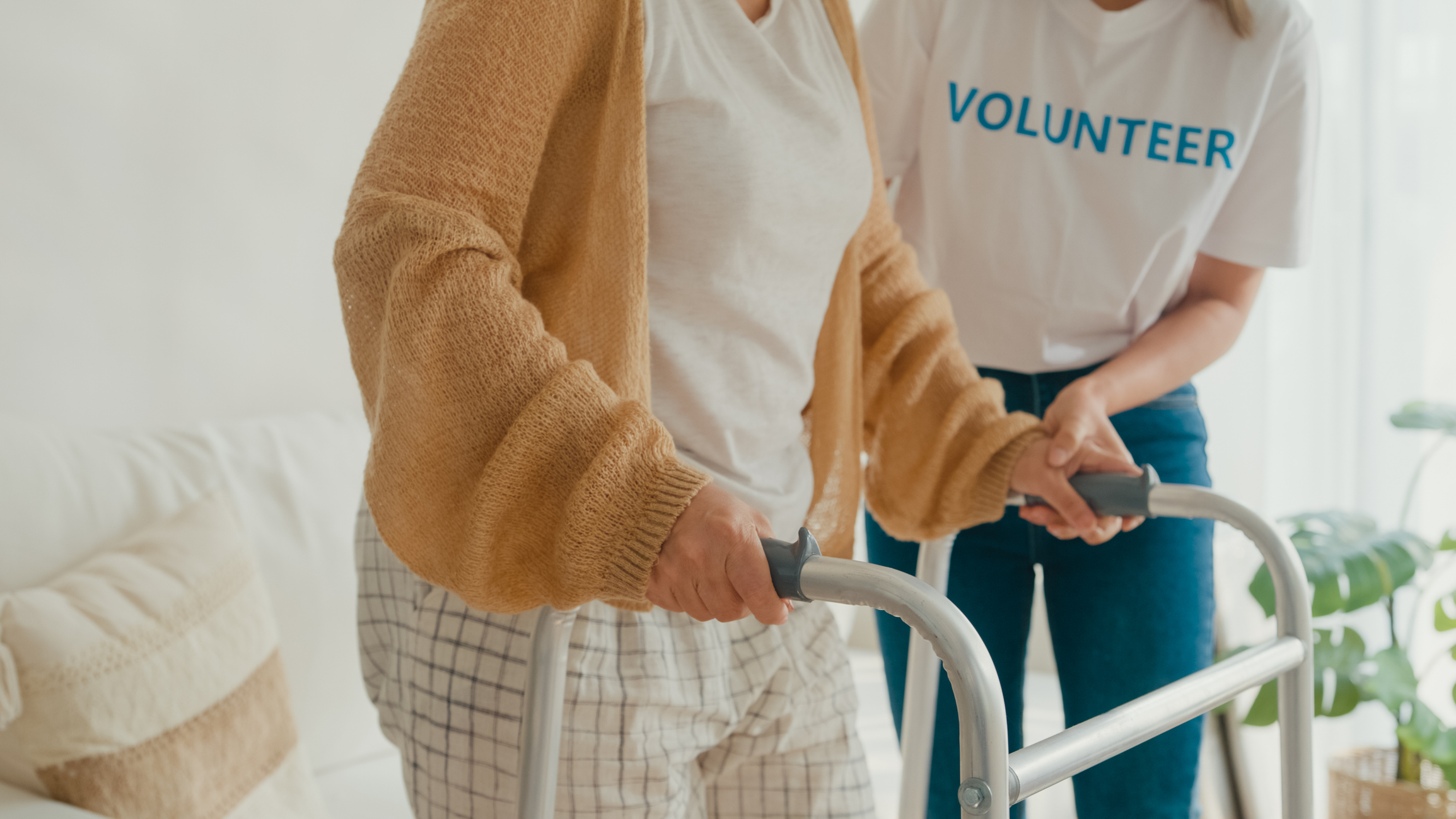 hospice-volunteer-helping-patient-with-walker-in-home